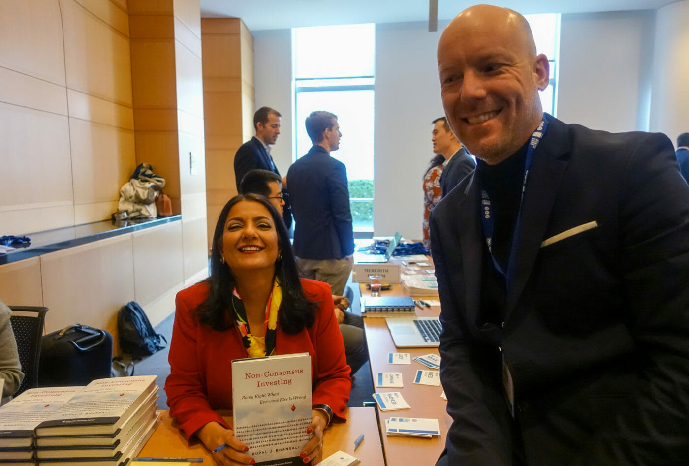 Swem Lorenz and Rupal Bhansali at the book table with the book "Non-consensus investing"