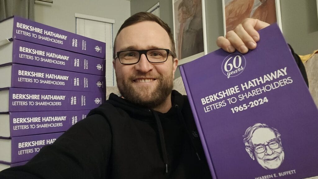 Tilman Versch holding the book of Warren Buffett letters to Berkshire Hathaway shareholders, 1965 to 2024