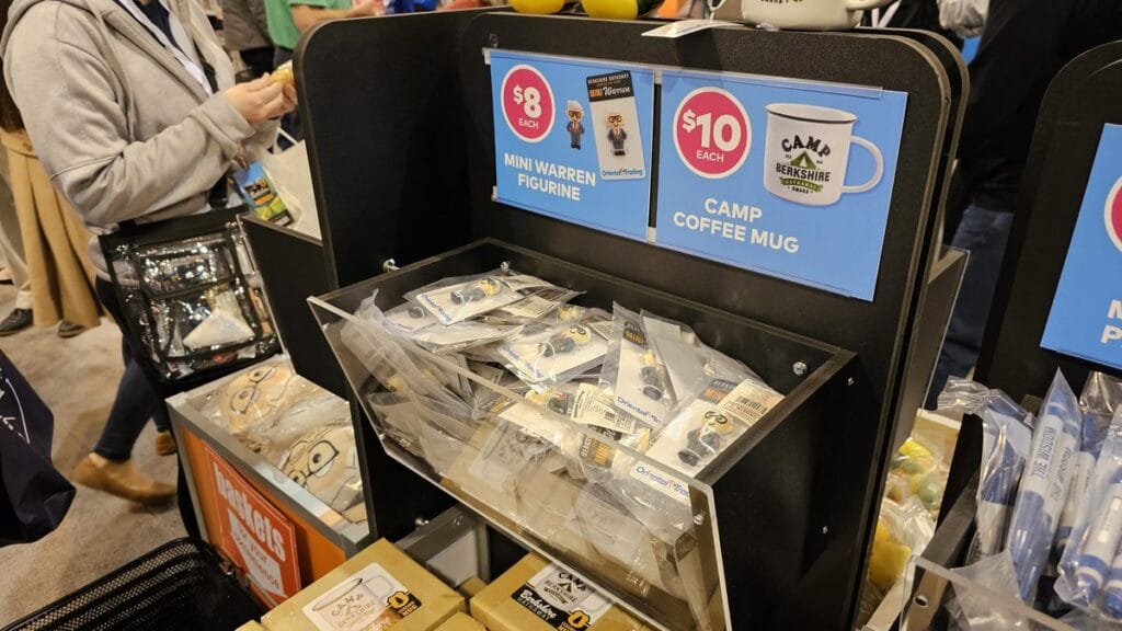 Berkshire souvenirs such as mini Warren figurines and Camp Berkshire mugs for sale in the exhibition hall, 2025
