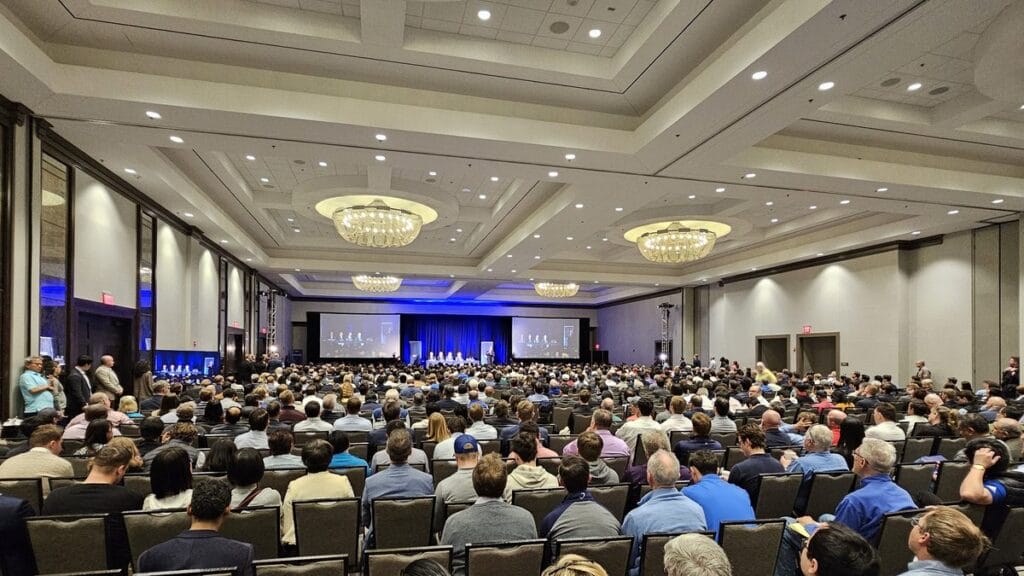 Full ballroom at the Markel Omaha Brunch 2025, the Markel leaders on stage and on both screens
